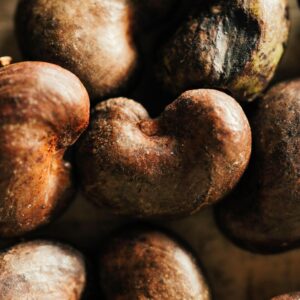 Close-up macro shot of raw cashew nuts showcasing texture and rustic freshness.